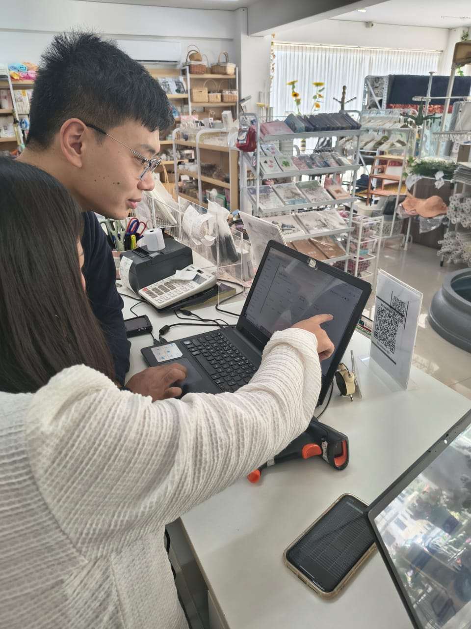 aBit consultants Novin and Manita training the My Home Plus owner on aBitPOS at the counter