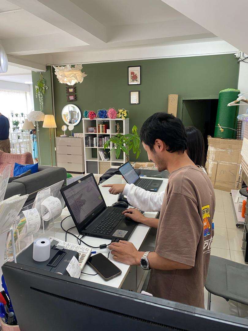 My Home Plus staff running aBitPOS at the counter amid the home decor showroom