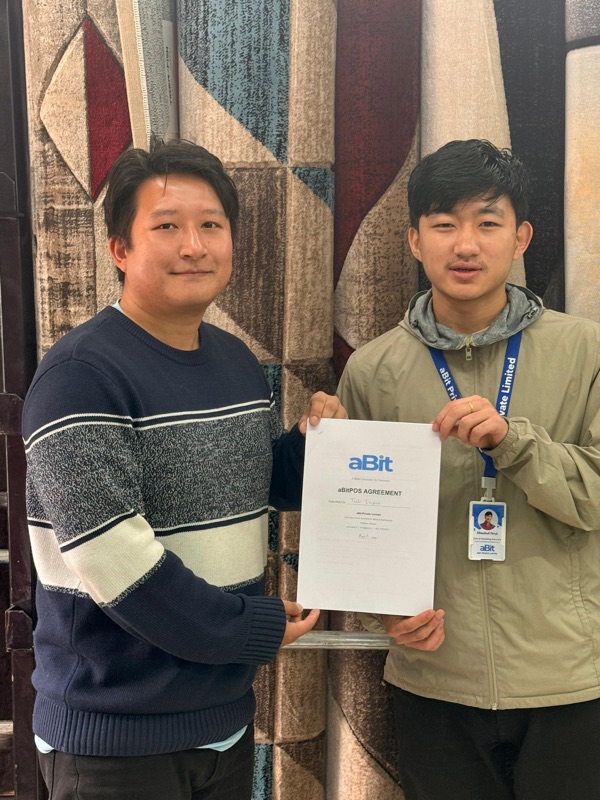 MKTS Home Decor owner with aBit team holding the signed aBitPOS agreement