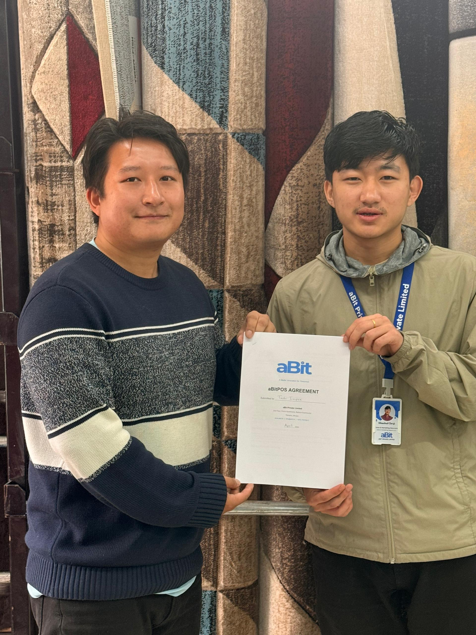 MKTS Home Decor owner with aBit team holding the signed aBitPOS agreement