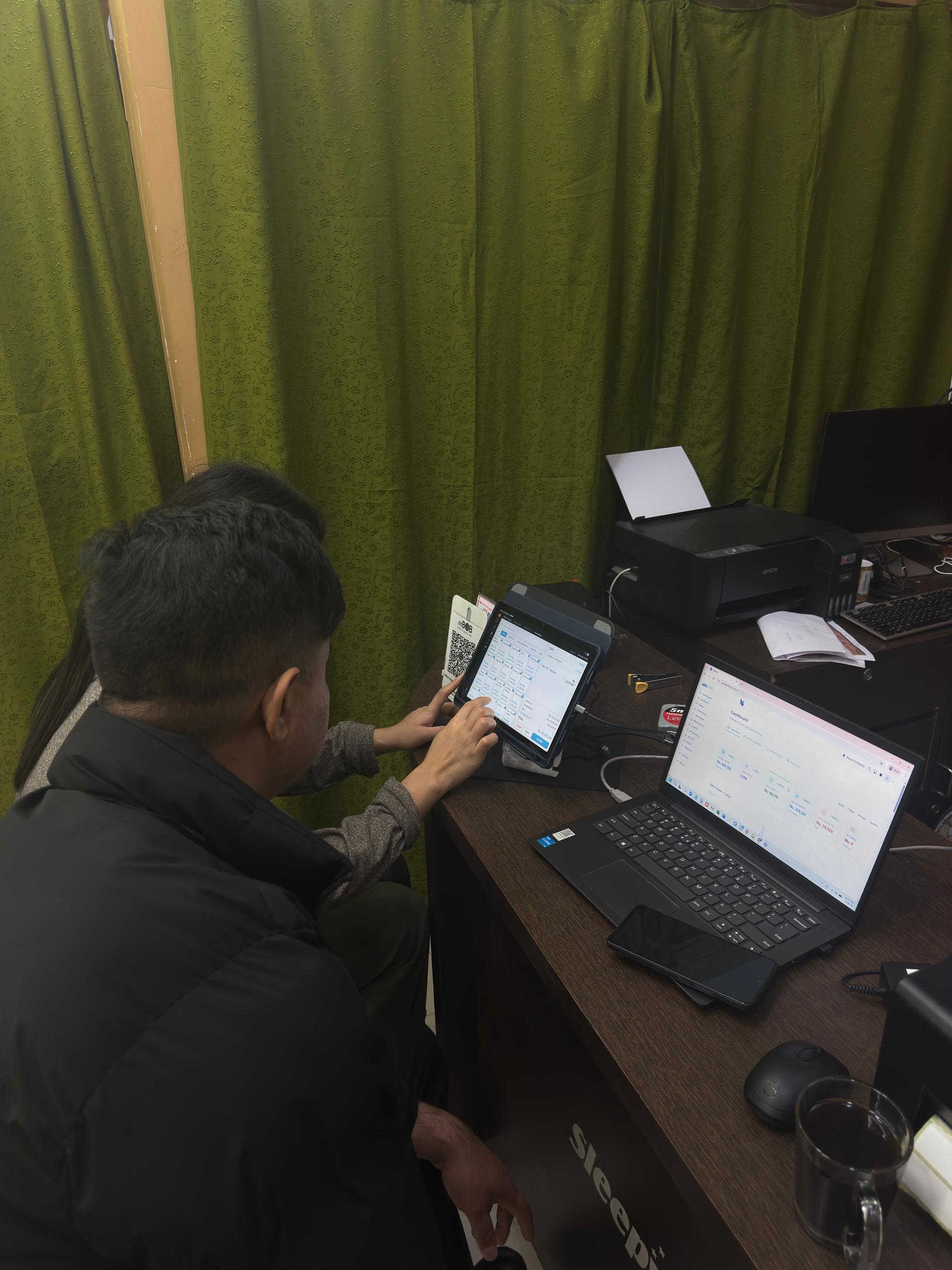 MKTS Home Decor staff operating aBitPOS on a touchscreen terminal with receipt printer alongside the Sleepwell display