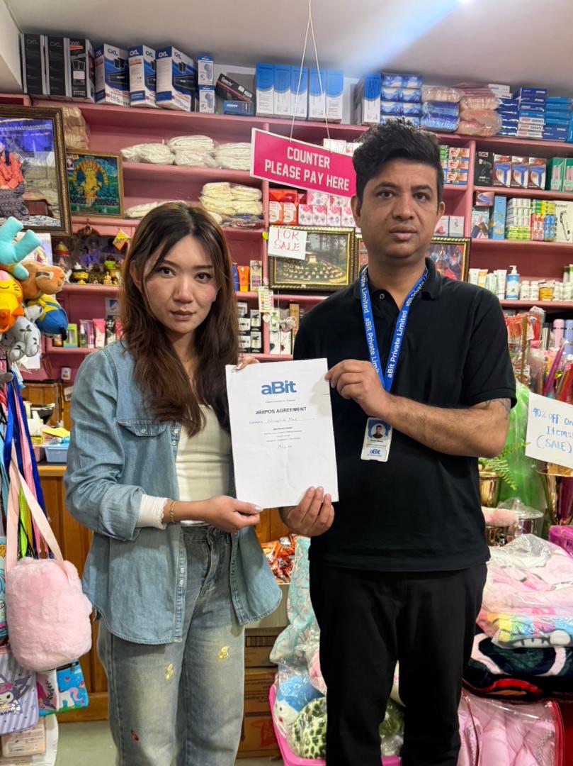 Wangchuk Mart owner with aBit consultant Novin Biswa and the signed aBitPOS agreement