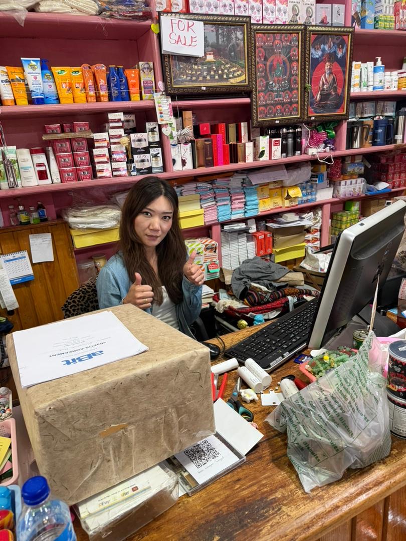 Wangchuk Mart owner at the counter running aBitPOS