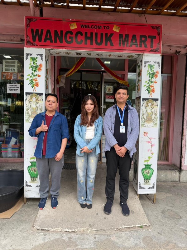 Wangchuk Mart team with aBit consultant Novin Biswa outside the Wangchuk Mart storefront